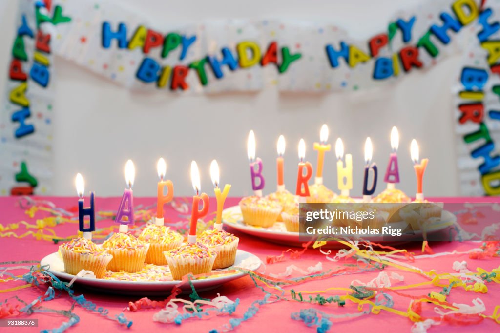 Happy Birthday candles on top of small cakes