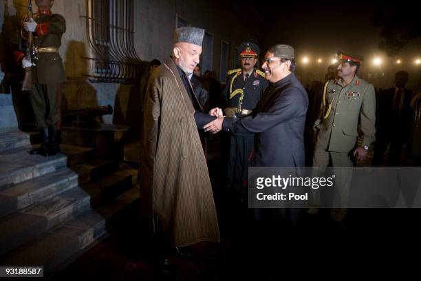 Afghan President Hamid Karzai shakes hands with Pakistan President Asif Ali Zardari at the presidential palace on November 18, 2009 in Kabul,...