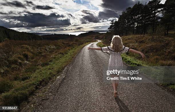 woman walking along a road, scotland - glenelg scotland stock pictures, royalty-free photos & images