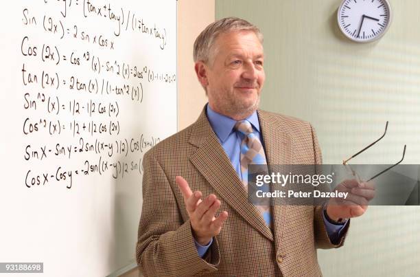 senior maths teacher in front of white board. - teacher in front of whiteboard stock pictures, royalty-free photos & images