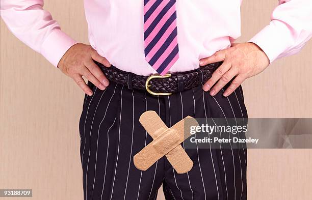man with plasters over crotch. - birth control stockfoto's en -beelden