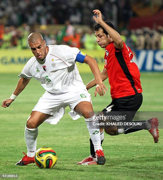 Egypt's Sayed Moawad challenges Algeria's Yazid Mansouri during their 2010 World Cup qualifying play-off football match in Khartoum on November 18,...