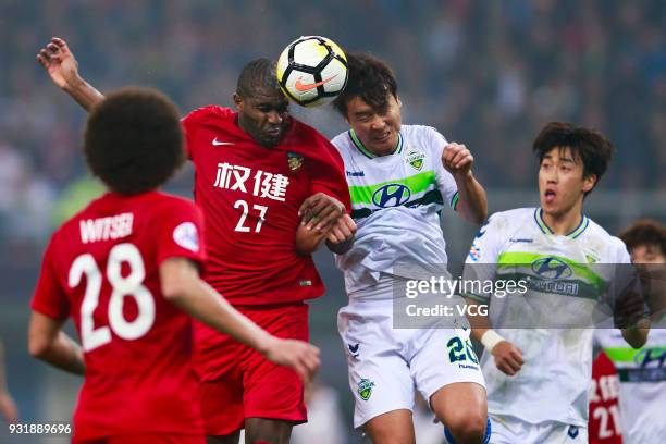 Anthony Modeste of Tianjin Quanjian and Lee Dong-Gook of Jeonbuk Hyundai Motors compete for the ball during the 2018 AFC Champions League Group E...