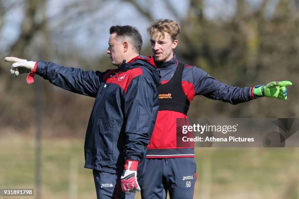 Tony Roberts, goalkeeping coach and Lewis Thomas gesture during the Swansea City Training at The Fairwood Training Ground on March 13, 2018 in...