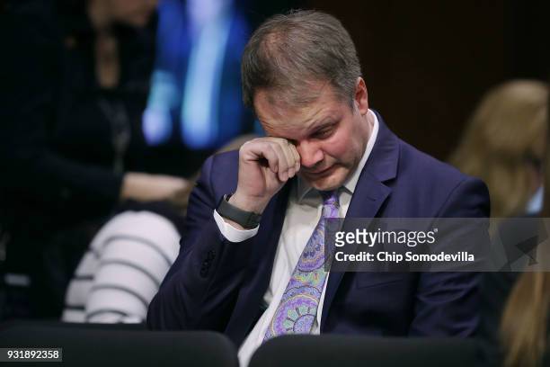 Ryan Petty, father of Alaina Petty, a student killed in the February 14 shooting in Parkland, Florida, wipes away tears while hearing testimony from...