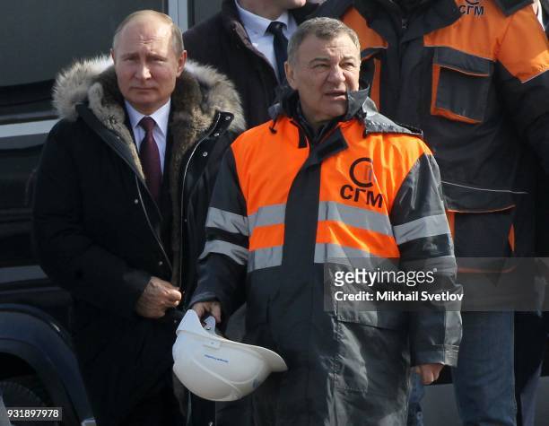 Russian billionaire and businessman Arkady Rotenberg looks on during a visit with Russian President Vladimir Putin to the construction site for the...