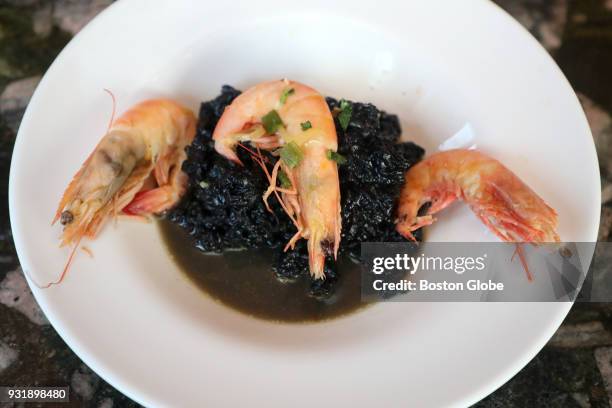 Shrimp, calamari, and black squid ink in seafood broth is pictured at Trattoria Nina in Arlington, MA on March 9, 2018.