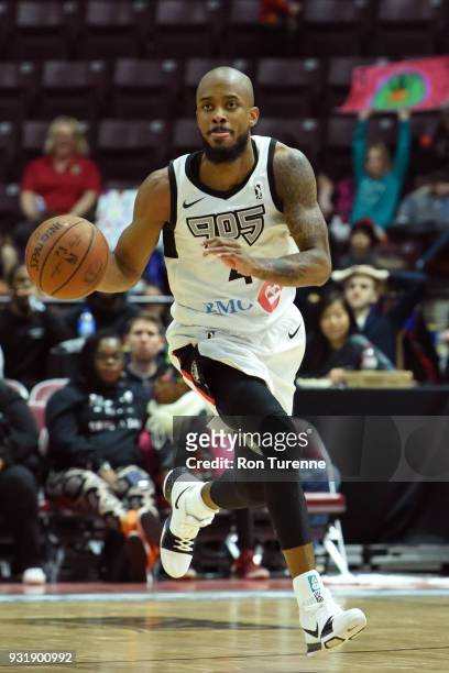 Lorenzo Brown of the Raptors 905 dribbles the ball against the Greensboro Swarm during the NBA G-League game at the Hershey Centre in Mississauga,...