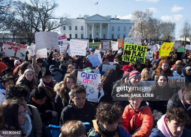 Thousands of local students sit for 17 minutes in honor of the 17 students killed last month in a high school shooting in Florida, during a...