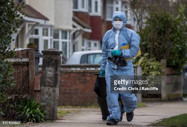 Police forensics officer walks down the road before entering a police tent outside the home of Russian exile Nikolai Glushkov who was found dead at...