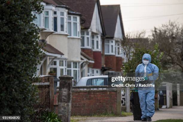 Police forensics officer walks down the road before entering a police tent outside the home of Russian exile Nikolai Glushkov who was found dead at...