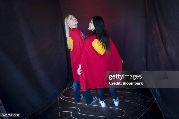 Attendees wearing Superman themed capes stand for a photograph during the South By Southwest conference in Austin, Texas, U.S., on Tuesday, March 13,...