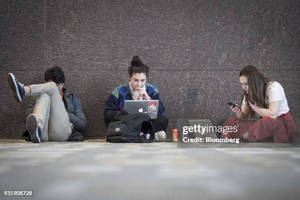 Attendees work on Apple Inc. Laptop computers at the South By Southwest conference in Austin, Texas, U.S., on Tuesday, March 13, 2018. Amid the...