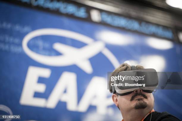 An attendee wears a Samsung Electronics Co. Galaxy Gear virtual reality headset at the South By Southwest conference in Austin, Texas, U.S., on...