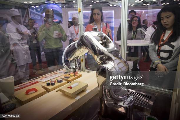 Attendees view a Team Open-Meals pixel food printer at the South By Southwest conference in Austin, Texas, U.S., on Tuesday, March 13, 2018. Amid the...