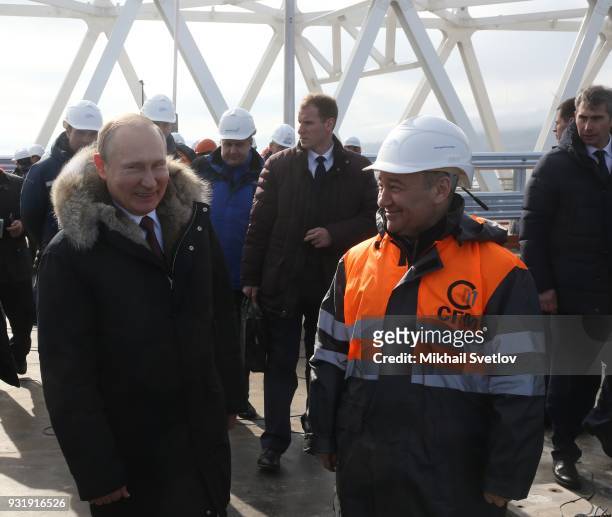 Russian President Vladimir Putin and Russian billionaire and businessman Arkady Rotenberg visit the construction site for the Crimean bridge which is...