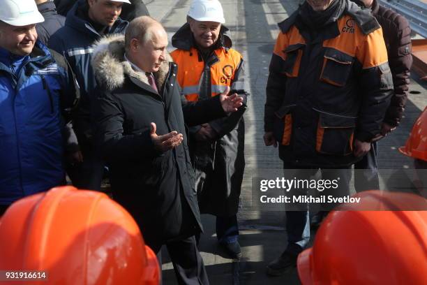 Russian President Vladimir Putin and Russian billionaire and businessman Arkady Rotenberg visit the construction site for the Crimean bridge which is...