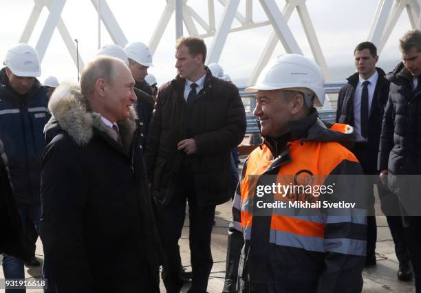 Russian President Vladimir Putin and Russian billionaire and businessman Arkady Rotenberg visit the construction site for the Crimean bridge which is...