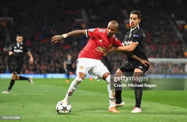 Ashley Young of Manchester United battles Wissam Ben Yedder of Seville during the UEFA Champions League Round of 16 Second Leg match between...