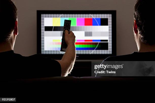 two men watching a test pattern on a television - testbild stock-fotos und bilder