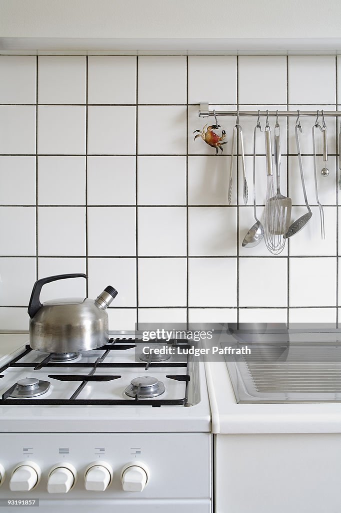 Detail of a stove and sink in a kitchen