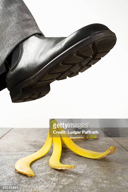 a foot above a banana peel - バナナの皮 ストックフォトと画像