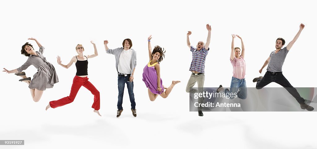 Men and women jumping mid-air together