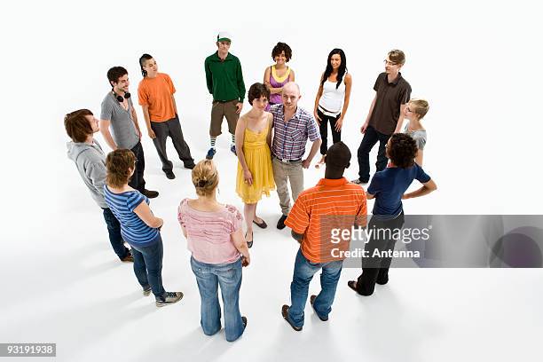 a couple surrounded by a group of men and women - omgeven stockfoto's en -beelden