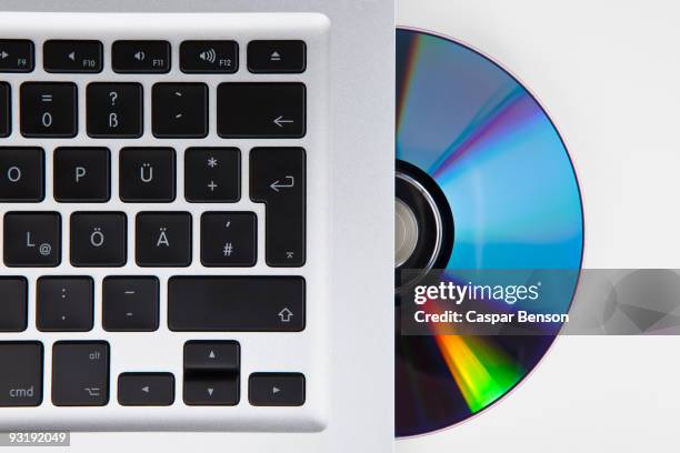 a cd-rom or dvd halfway in a german laptop - cd drive stock pictures, royalty-free photos & images