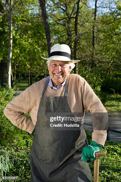 a senior man dressed for gardening taking a break - panama hat stock pictures, royalty-free photos & images