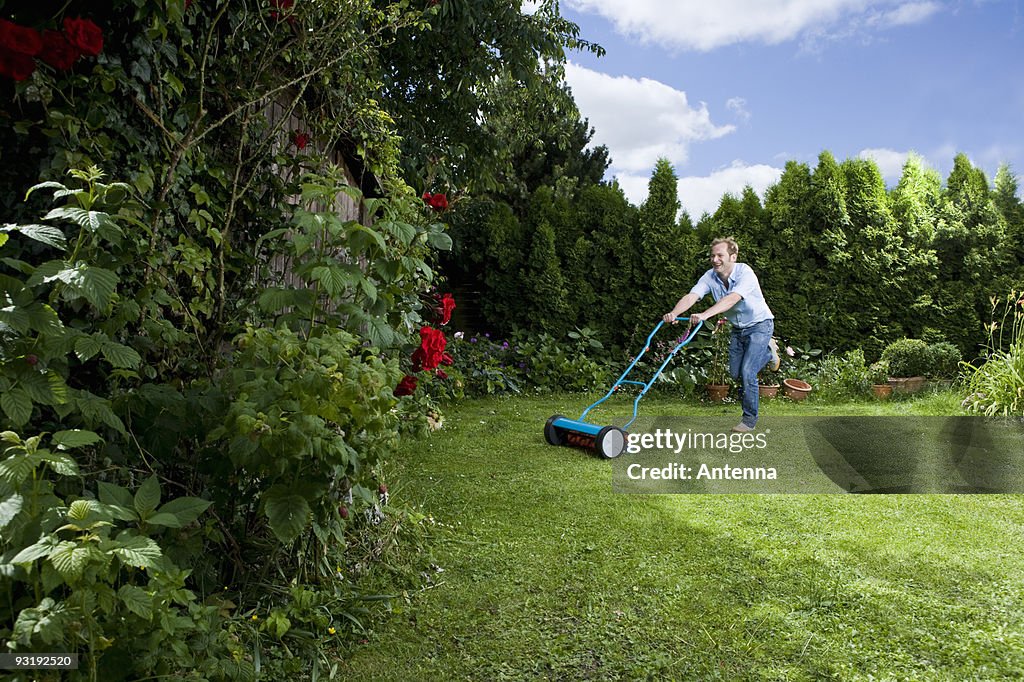 A man pushing a mower