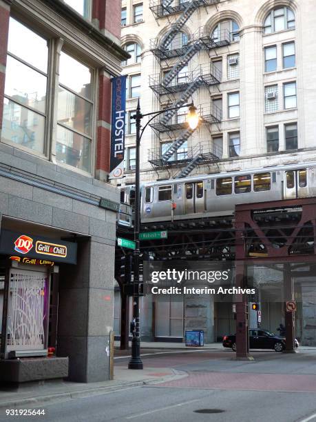 View of the intersection of E Congress Parkway and S Wabash Avenue as a train passes by on elevated tracks, Chicago, Illinois, March 2, 2018.