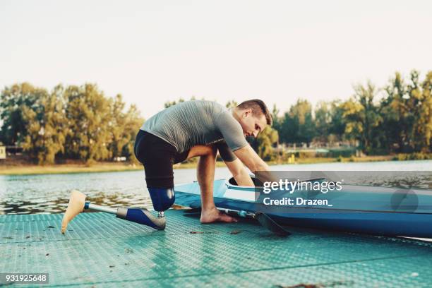 courageous amputee sportsman with kayak - mental disability stock pictures, royalty-free photos & images