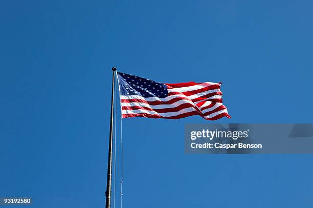 american flag flying - flagpole stock-fotos und bilder