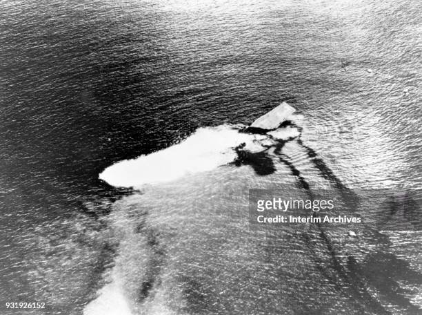 Aerial view of the aircraft carrier USS Saratoga as it sinks after the Baker Day atomic bomb test, off the Bikini Atoll, Marshall Islands, July 25,...