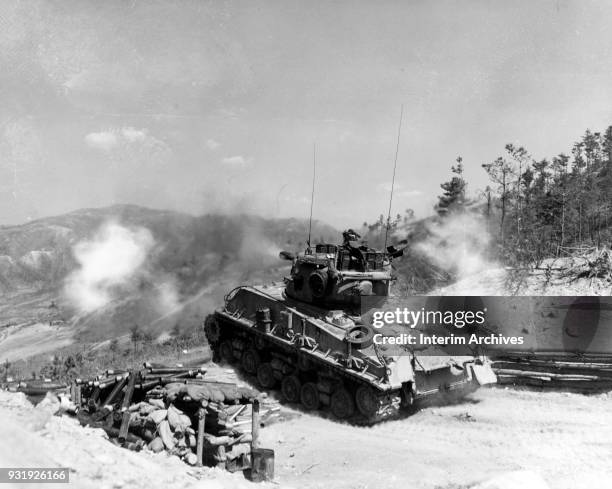 Near Hill 854, the 76mm gun of a M4 Sherman tank from Company B, 72nd Tank Battalion fires towards enemy bunkers on Napalm Ridge as they support the...