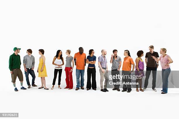 group of men and women standing in a row and talking - group of people ストックフォトと画像