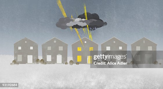 A row of houses with a storm cloud over one house A row of houses with a storm cloud over one house