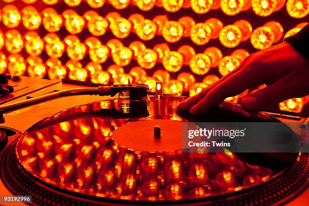 a dj scratching a record at a nightclub - dj club foto e immagini stock