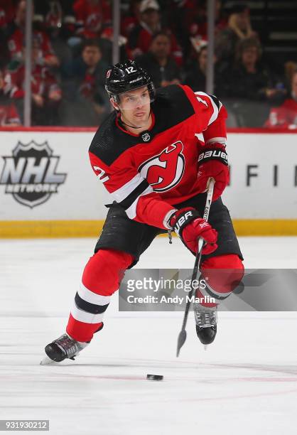 Ben Lovejoy of the New Jersey Devils plays the puck during the game against the Winnipeg Jets at Prudential Center on March 8, 2018 in Newark, New...