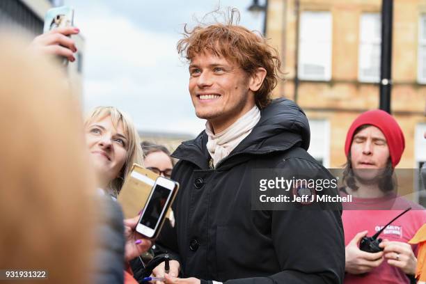 Sam Heughan from the TV series Outlander meets fans who were waiting in St Andrew's Square on March 14, 2018 in Glasgow, Scotland. Dozens of fans...
