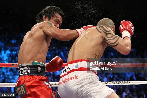 Manny Pacquiao throws a right to the head of Miguel Cotto during their WBO welterweight title fight at the MGM Grand Garden Arena on November 14,...