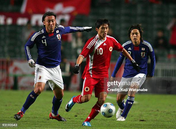 Marcus Tulio Tanaka and Yasuhito Endo of Japan and Au Yeung Yiu Chung of Hong Kong compete for the ball during AFC Asia Cup 2011 Qatar qualifier...