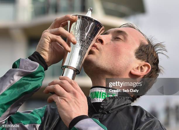 Cheltenham , United Kingdom - 14 March 2018; Jockey Nico de Boinville celebrates with the trophy after winning the Betway Queen Mother Champion...