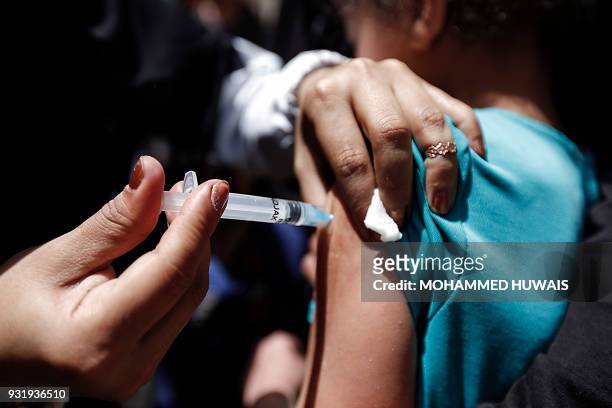 Yemeni child receives a diphtheria vaccine at a health centre in the capital Sanaa on March 14, 2018. More than eight million Yemenis are at risk of...