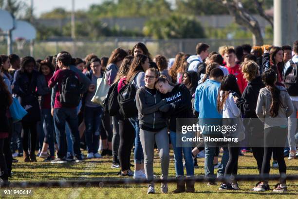 Students stand outside during the ENOUGH: National School Walkout rally at Marjory Stoneman Douglas High School in Parkland, Florida, U.S., on...