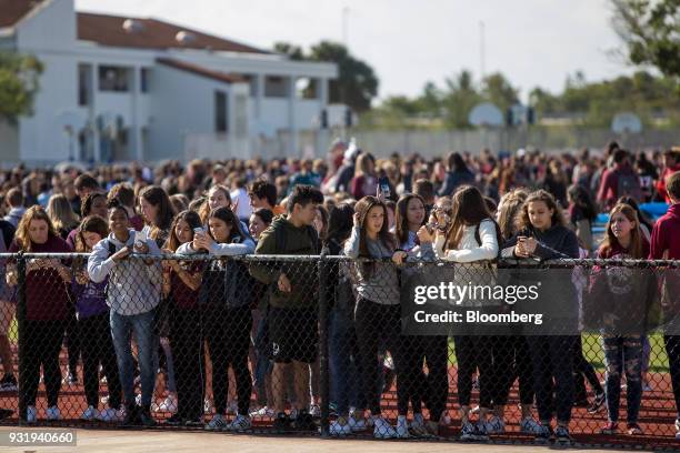 Students stand outside during the ENOUGH: National School Walkout rally at Marjory Stoneman Douglas High School in Parkland, Florida, U.S., on...