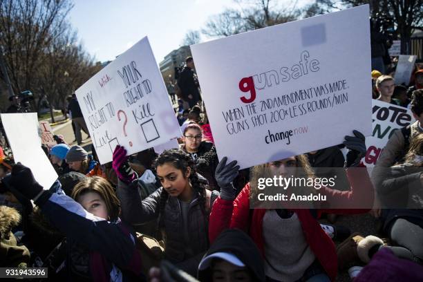 Thousands of students sit in silence with their backs to the White House for 17 minutes for the 17 people killed by a gunman in the shooting at...