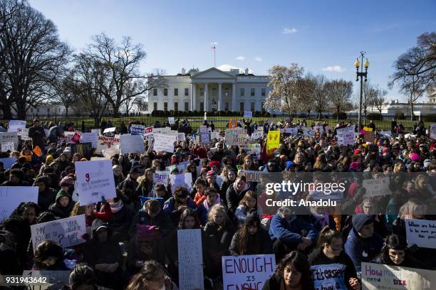 Thousands of students sit in silence with their backs to the White House for 17 minutes for the 17 people killed by a gunman in the shooting at...