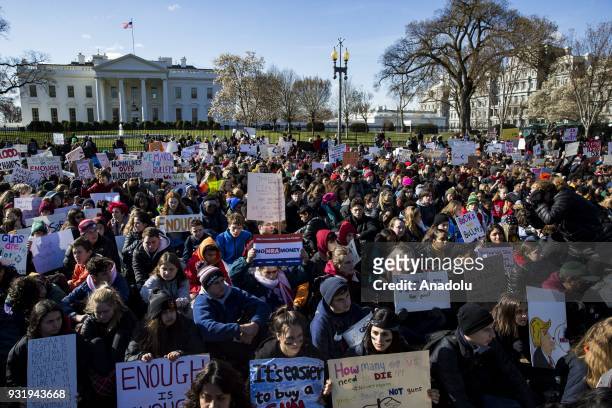 Thousands of students sit in silence with their backs to the White House for 17 minutes for the 17 people killed by a gunman in the shooting at...